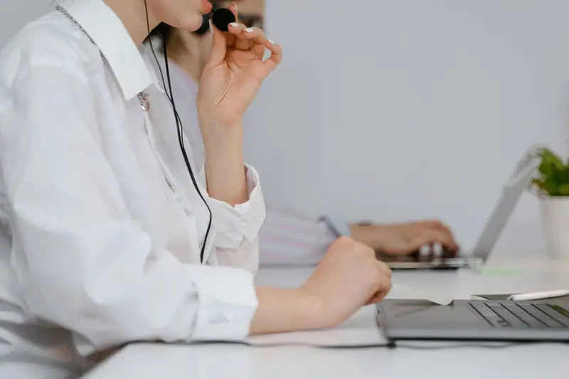 A customer service adviser with a headset taking a call