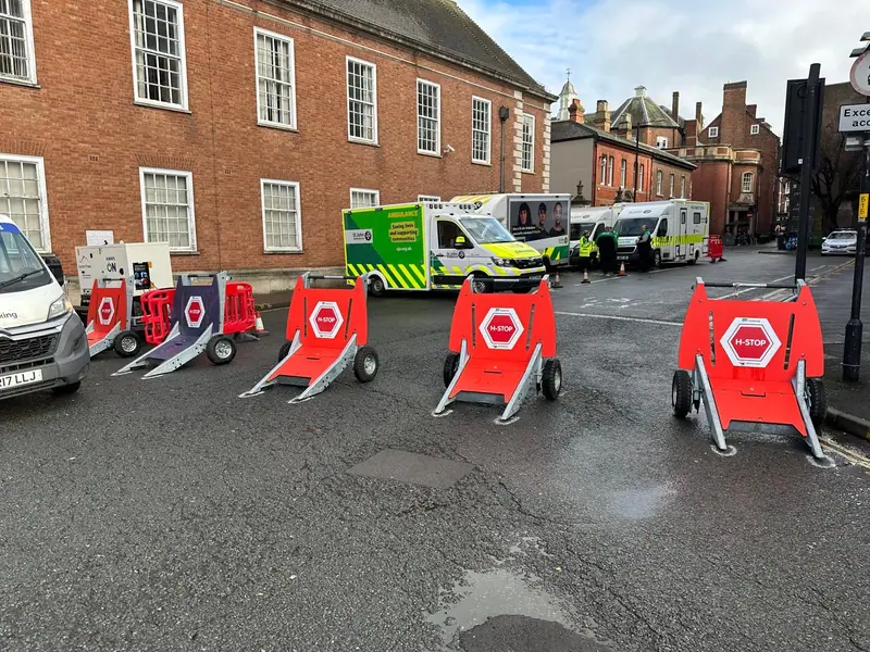 A row of H-Stop hostile vehicle mitigation barriers across a town centre road