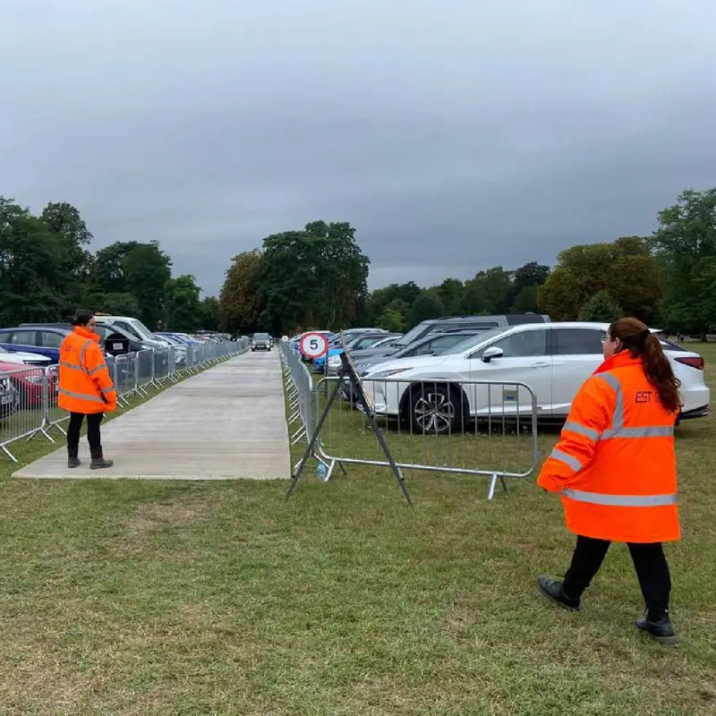 EST staff setting out a temporary event car park on grass