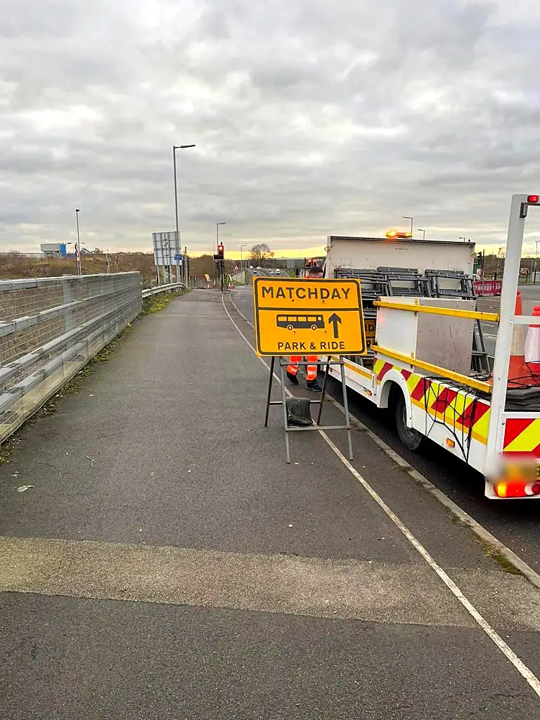 A Matchday Park and Ride sign set out beside an EST traffic management vehicle