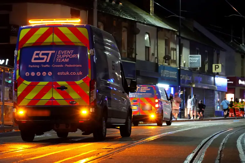 EST vans with chevrons and beacons working a road in Sheffield at night, Tramlines Festival 2026